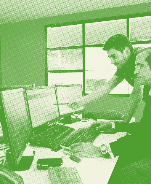 Two technicians analysing Dalkia energy audit data